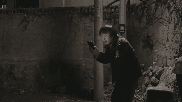 Man getting angry at his smartphone on the street at night