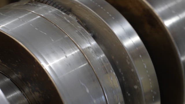 Close-up of metal rollers in operation