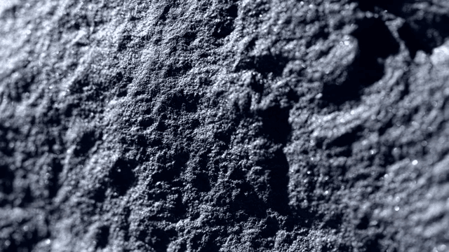 Surface of a dark rock illuminated by light