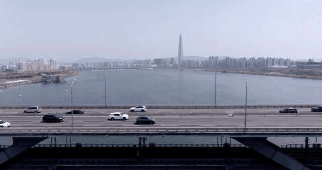 A bridge over a river with city skyline