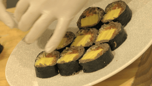 Arranging futomaki on plate