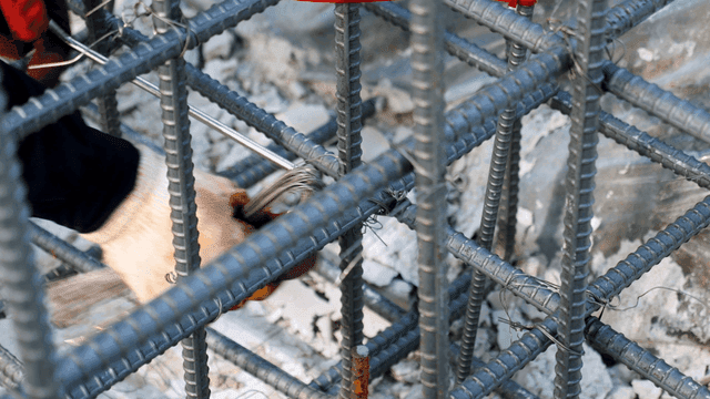 Worker tying rebar at a construction site