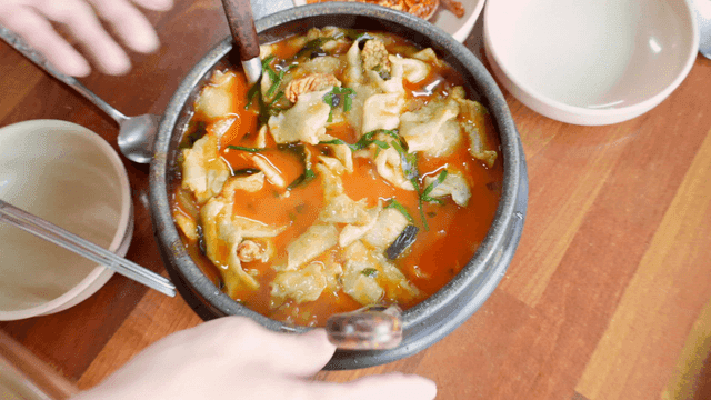 Spicy handmade dumplings steaming on table