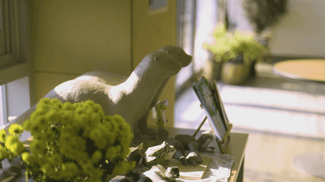 Desk with otter sculpture and plants
