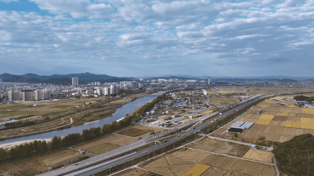 Cityscape with fields and a river