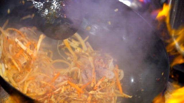 Stir-frying in a flaming wok at high heat