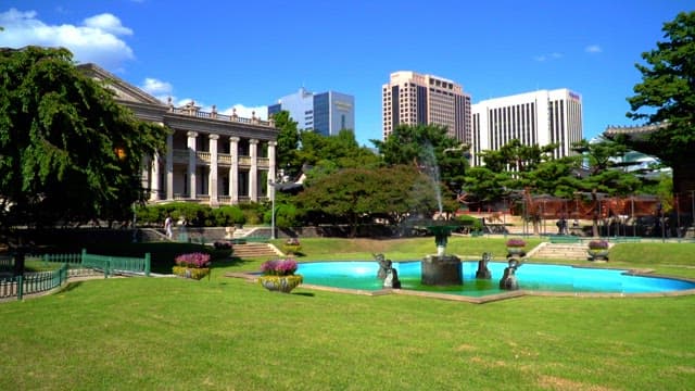 Deoksugung Seokjojeon Hall with fountain and green garden in the city center