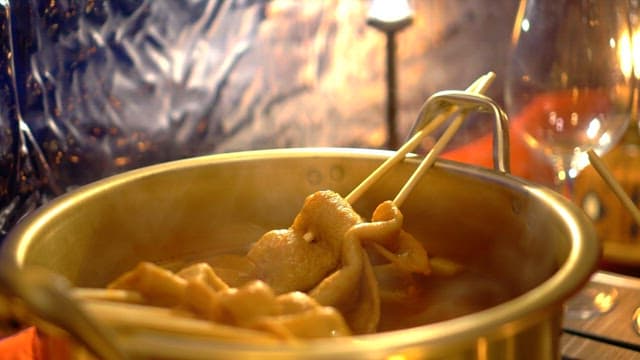 Fish cake soup inside the tent is boiling deliciously in a pot