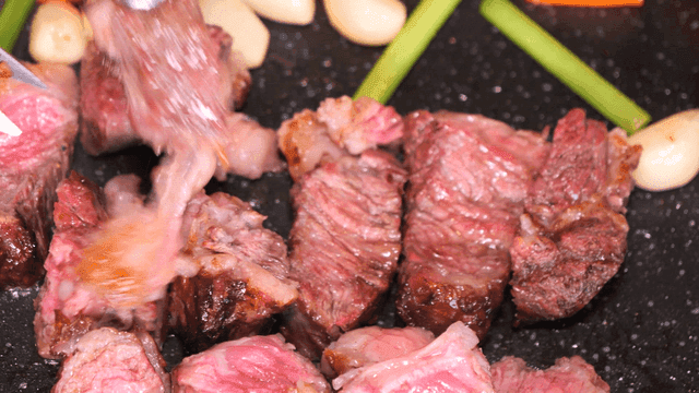 Juicy beef cubes grilling with vegetables