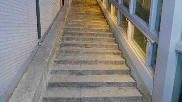 Well-lit staircase in an urban alley