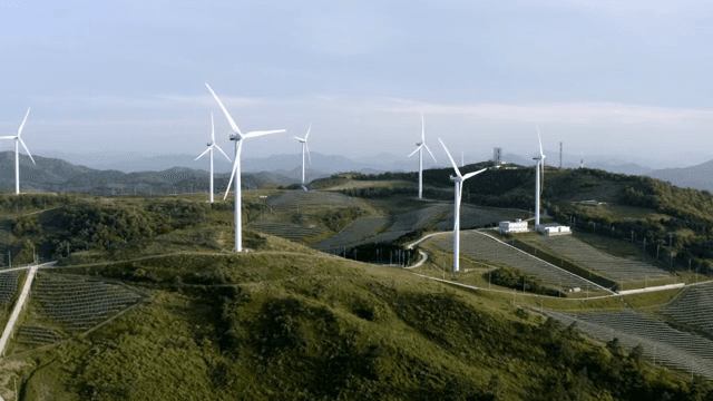 Wind turbine in a lush green mountain area