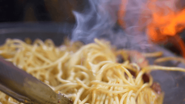 Octopus and noodles being cooked together