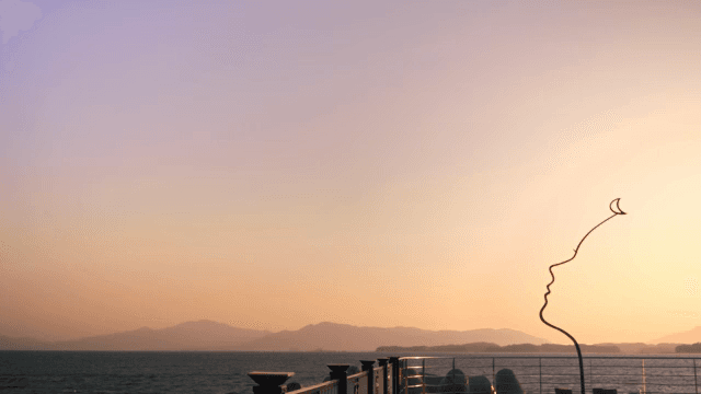 Sunset view over the ocean with sculpture