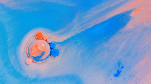 Abstract pattern of red and orange liquids mixing together