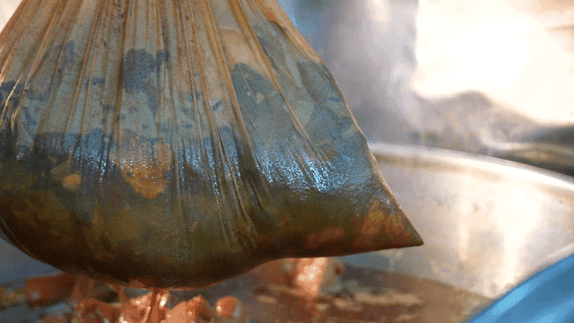 Pig's trotters broth strainer taken out of large pot