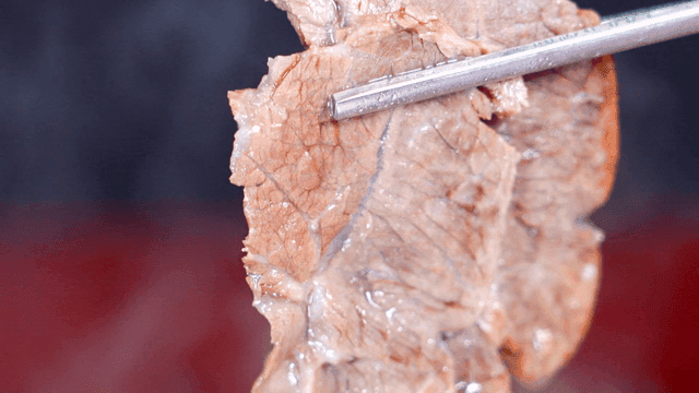 Cooked beef shank held with chopsticks