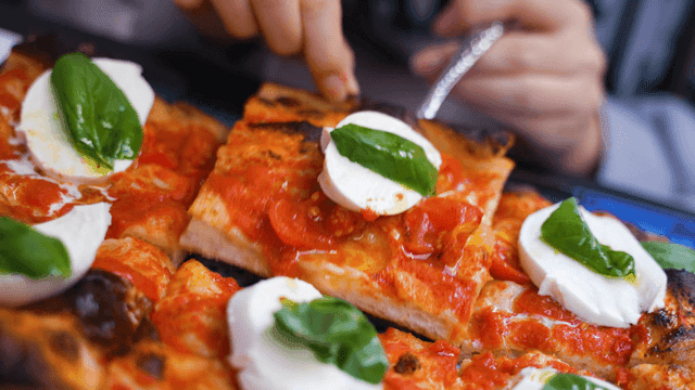 Freshly baked pizza with mozzarella and basil