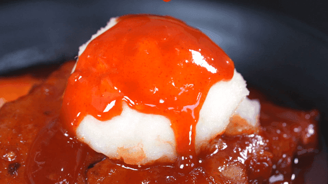 Tteokbokki sauce being poured over potato salad