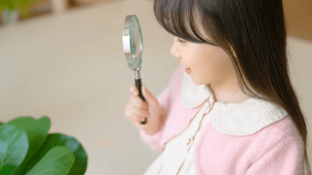 Child exploring with a magnifying glass