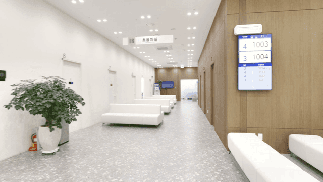 Hospital lounge in front of ultrasound room with white sofas