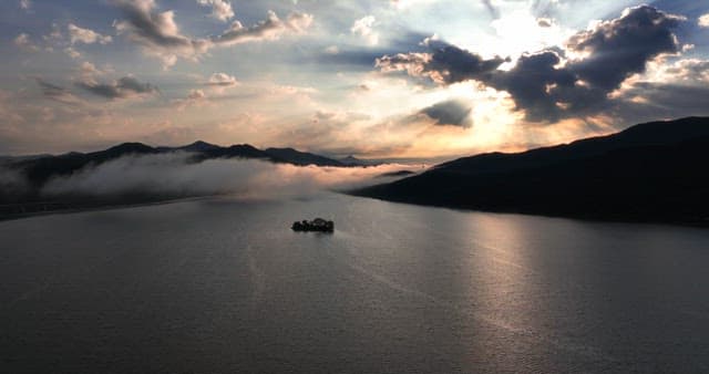 Serene river with misty mountains