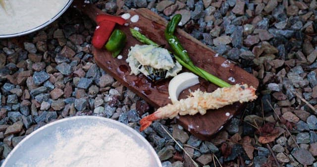 Preparing fried food outdoors with a portable stove