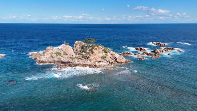 Rocky island surrounded by blue ocean