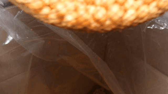 Scene of sifting gangjeong crumbs through a sieve