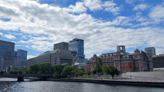 Cityscape with buildings and river under clear sky