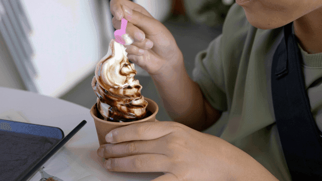 Person eating chocolate ice cream