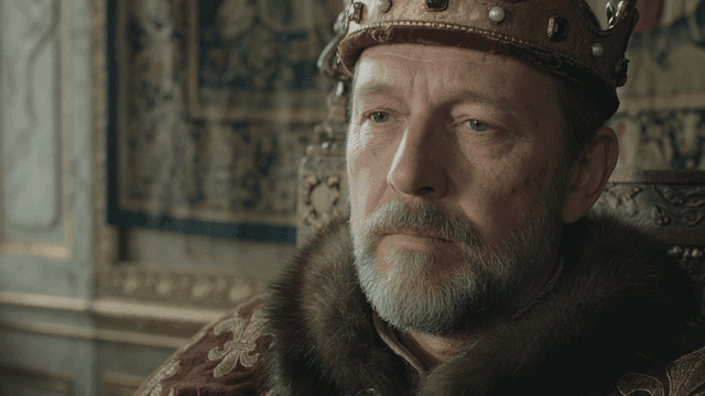Medieval European king sitting on throne
