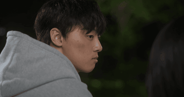 Profile of young man in hoodie looking at woman