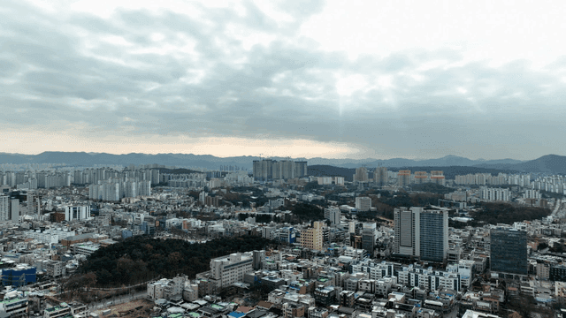 City landscape spread out under cloudy sky