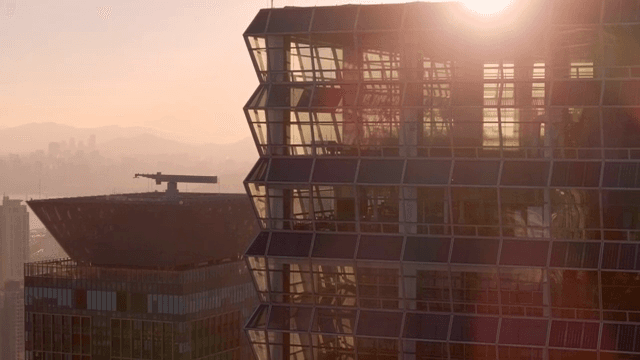 Modern skyscraper reflecting sunset