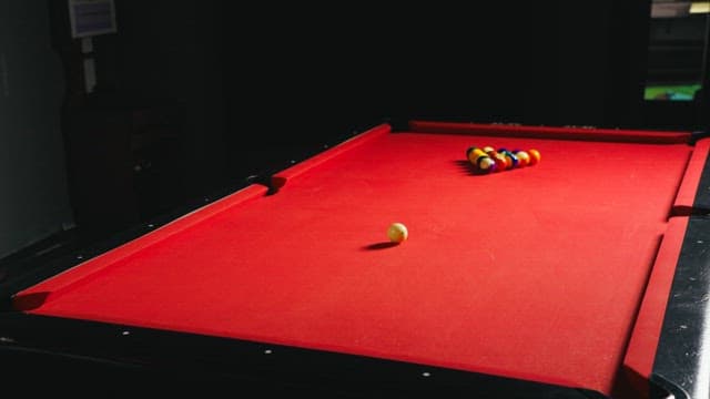 Man Playing a Game of Pool Indoors