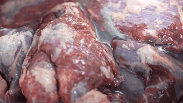 Water poured over raw meat in pot