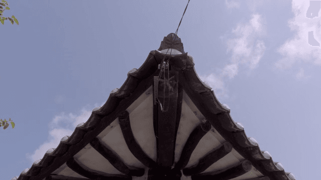 Traditional Korean roof under a clear sky