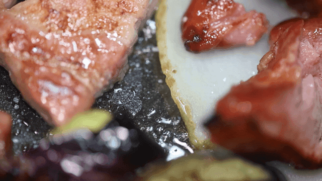 Sizzling meat and vegetables on a grill
