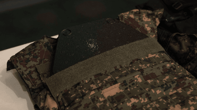 Camouflage military vest on display