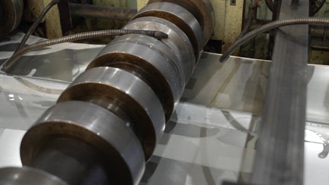 Metal sheet being processed in a factory