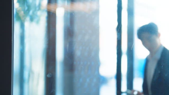 Man in a suit entering a building