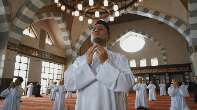 Men praying in a mosque with focus