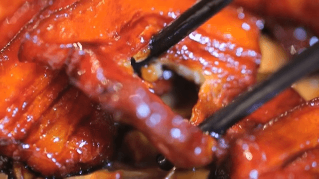 젓가락으로 윤기나는 홍소육 찢기