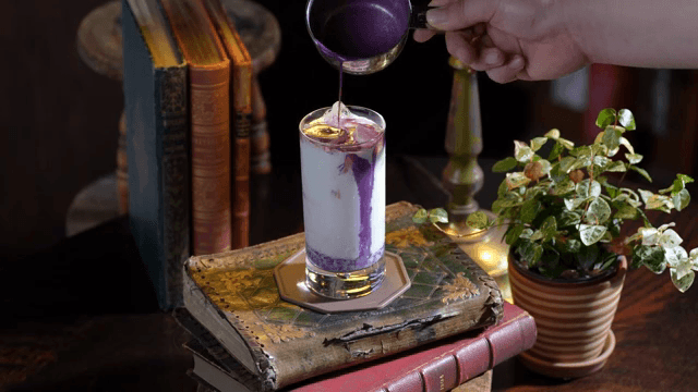 Glass of milk with purple syrup