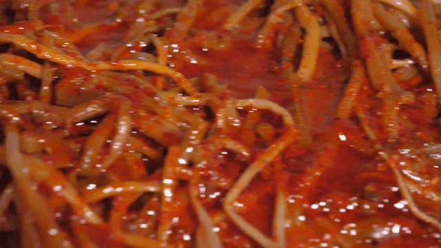 Boiled Sweet Potato Stems with Spicy Sauce Being Poured