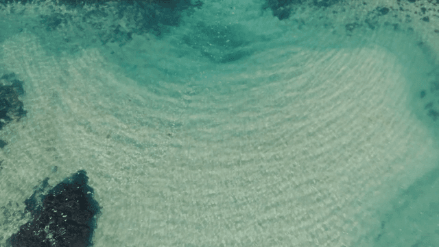 Clear turquoise sea with rocky barriers