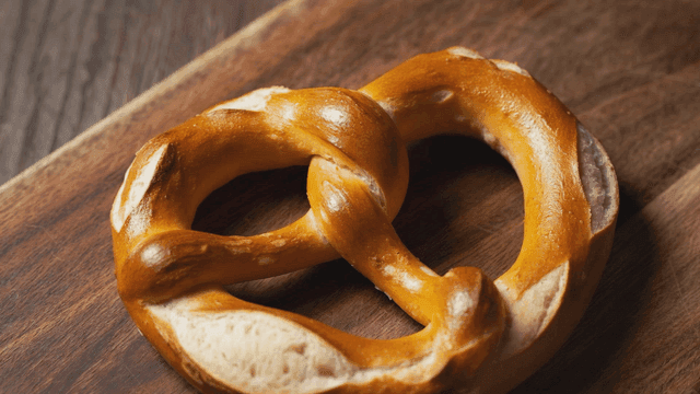 Freshly baked pretzels on wooden cutting board