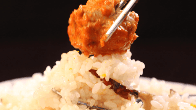Spoonful of rice topped with seasoned braised anglerfish