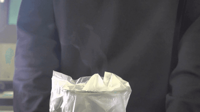 Person standing near a steaming cup