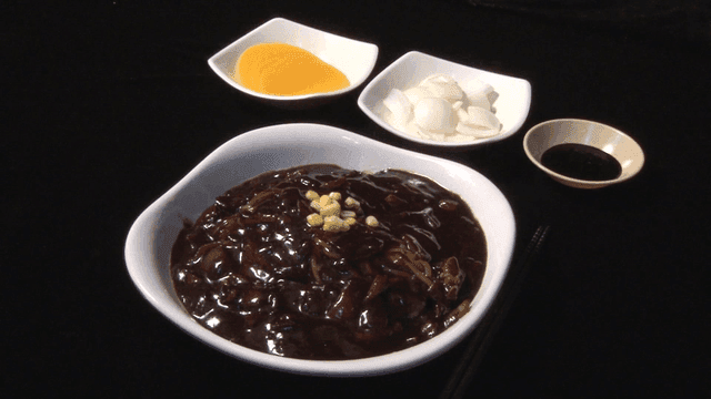 Noodles in black bean sauce on a table